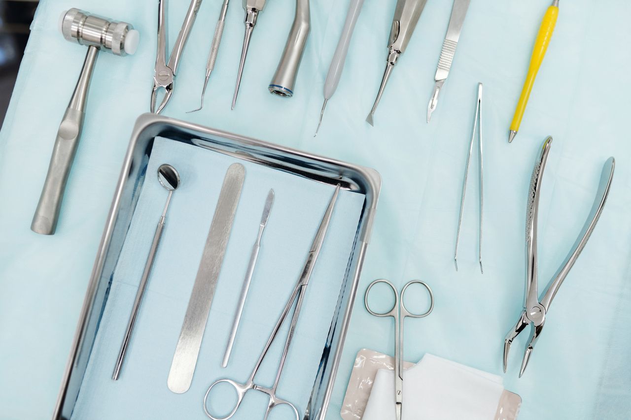 our-story Top view of various dental instruments arranged on a tray, ideal for medical use.