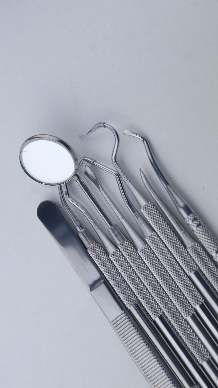 The Art of Drawing Readers In: Your attractive post title goes here A set of dental instruments neatly arranged, showcasing essential tools for dental care.